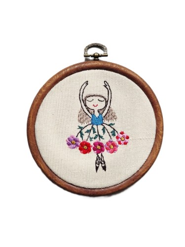 tamborek z haftem przedstawiającym tańczącą dziewczynkę w kwiecistej spódnicy